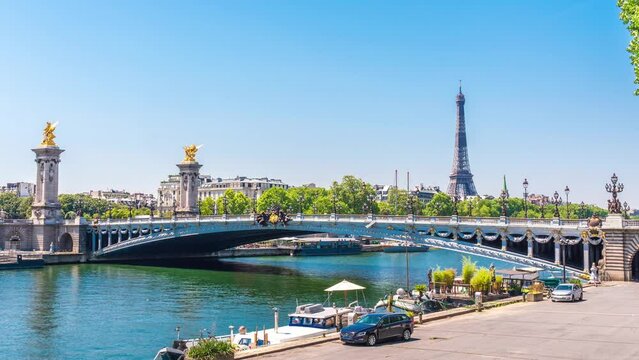 A timelapse of the Eiffel Tower along the river Seine with flyboats passing by with motion blur.Sunny but cloudy spring summer day paris city famous riverside bay tower view bridge timelapse panorama