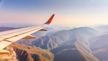 A view across a wing of a commercial plane flying over the blue mountains
 - Powered by Adobe