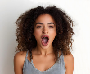 Surprised Young African American Woman with Curly Hair Expressing Shock in Casual Tank Top