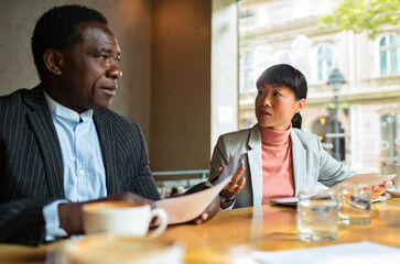 Business meeting in a cafe with diverse professionals