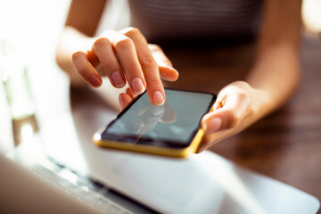 Close-up of woman's hand using a smartphone