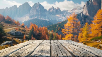 Wooden table top on blurred background of autumn color landscape in dolomites - for display your products