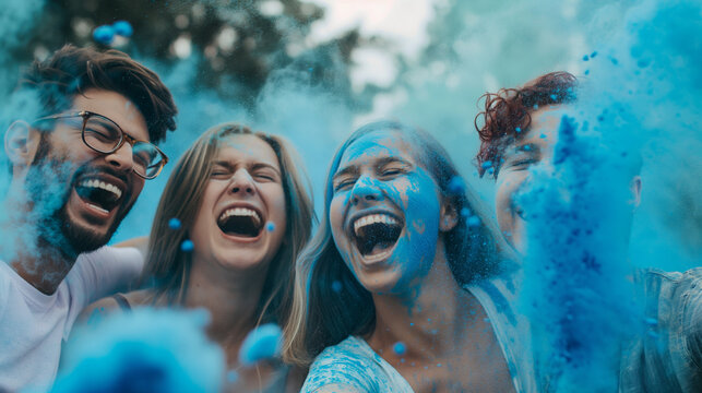 Energetic friends throwing blue color powder, enjoying a vibrant, joyful celebration