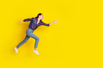 Full length photo of lovely young lady running fast black friday dressed stylish plaid garment isolated on yellow color background