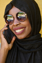 Digital Connection: Close-up Portrait of a Middle Eastern Teenage Muslim Girl Using Smartphone