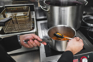 chef cooking vibrant seafood soup on kitcen