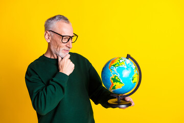 Photo portrait of nice senior man look thoughtful globe dressed stylish green clothes isolated on...