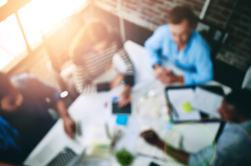 Meeting, boardroom and teamwork in office with overhead, blurred and lens flare. Planning, strategy and documents for collages and design for creative agency, advertising and business people