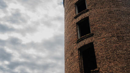 Brick tower overlooking the cloudy sky