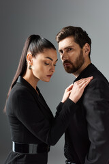 A loving, appealing couple in elegant attire standing together.