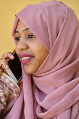 Digital Connection: Close-up Portrait of a Middle Eastern Teenage Muslim Girl Using Smartphone