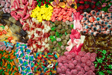 Background of colored chewy gelatin sweets, close-up, top view.