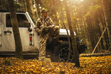 Caucasian Hunter Sitting on SUV offroad vehicle © Tomasz Zajda