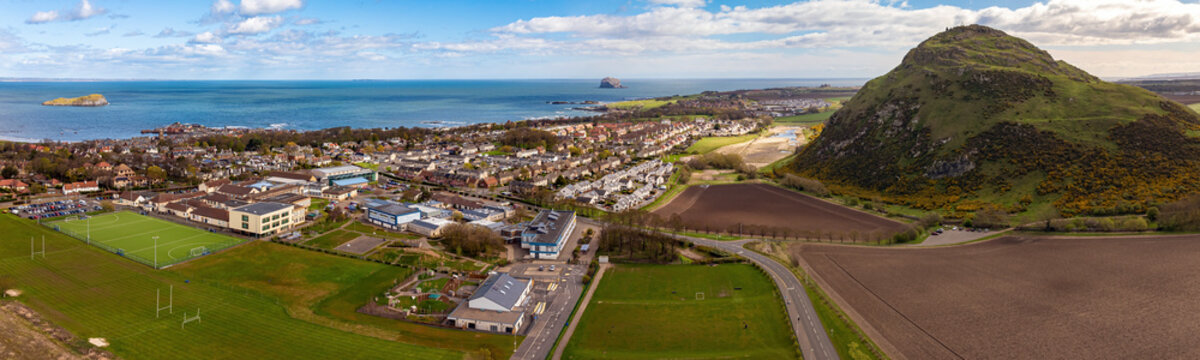 Aerial view of beautiful coastline at sunset, North Berwick Law, Scotland.