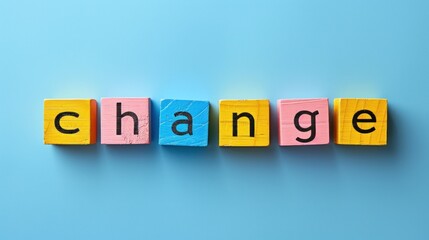 Wooden blocks arranged to spell out the word change on a blue background