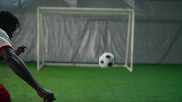 Professional soccer player training in stadium, scoring goal to gate, slowmotion