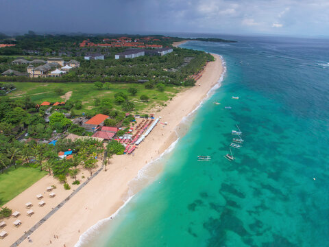 Aerial view of turquoise waters and sandy shore at Geger Beach, Nusa Dua, Bali, Indonesia.