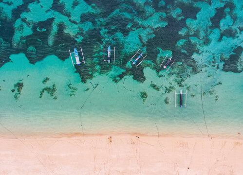 Aerial view of beautiful beach with pirogues, Uluwatu Peninsula, Pantai Nusa Dua, Bali, Indonesia.