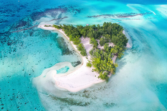 Aerial view of turquoise lagoon in Bora Bora, Motu Tapu, French Polynesia.