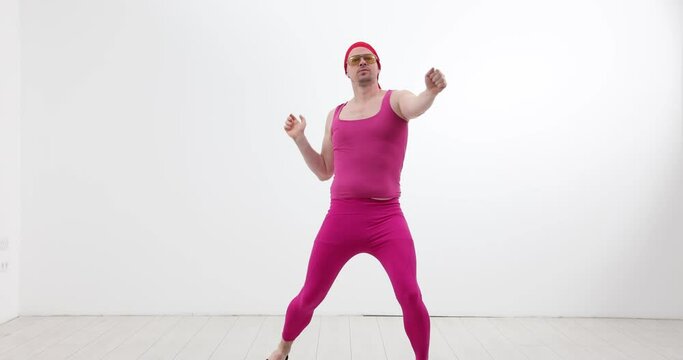 Transgender man dancing in pink suit on white background 4k movie slow motion. Positive mood concept