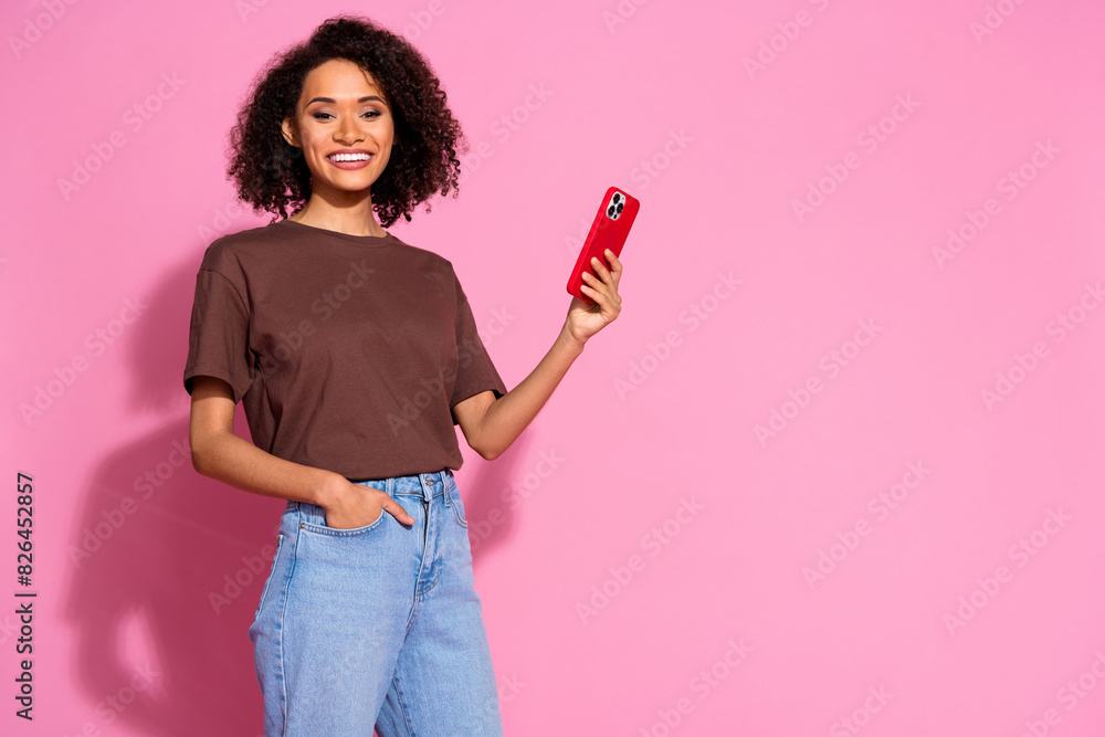 Sticker Photo of charming cute girl wear brown trendy clothes hold modern device empty space isolated on pink color background