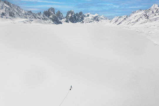 Aerial view of snowy Sim Gang glacier with Ski expedition, Shigar, Gilgit-Baltistan, Pakistan.
