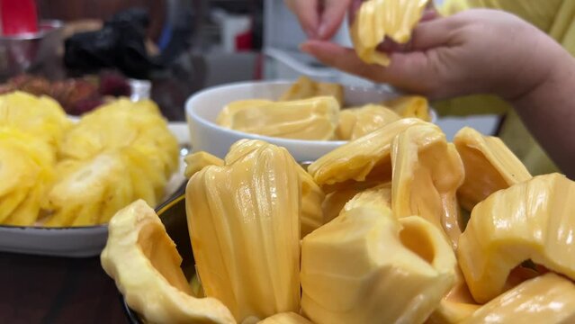 Break apart breadfruit jackfruit and prepare fruit for eating.