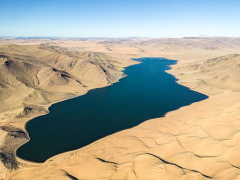 Aerial view of Baga Lake with mountainous landscape, Erdenekhairkhan, Zavkhan, Mongolia.