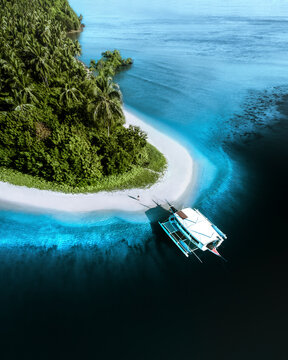 Aerial view of tropical seaside with catamaran and person, Port Barton, San Vicente, Palawan, Philippines.