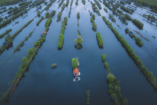 Aerial view of marsh landscape with floating houses and boats, Scheendijk, The Netherlands.