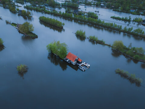 Aerial view of flooded Scheendijk with floating houses and boats, Breukelen, The Netherlands.
