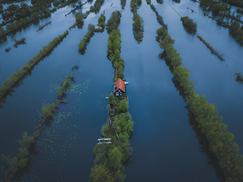 Aerial view of marsh landscape with floating houses and boats, Scheendijk, The Netherlands.