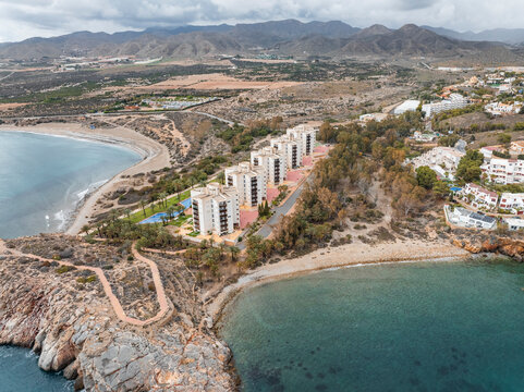 Aerial view of tropical paradise with turquoise water and palm trees, Isla Plana, Spain.