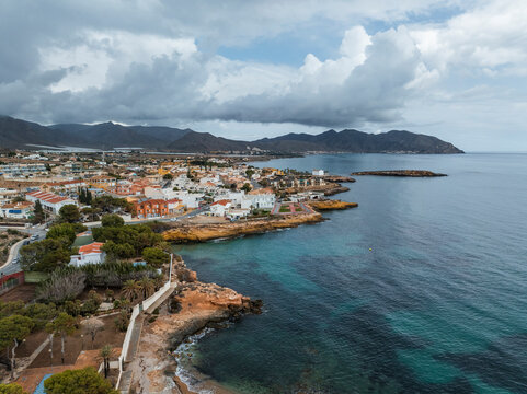 Aerial view of coastal town at sunset, Isla Plana, Murcia, Spain.