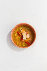 Traditional Fish Soup with Two Types of Fish in Clay Bowl on White Background