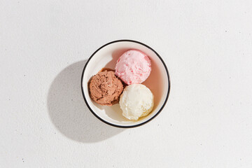 Delicious Trio of Ice Cream Scoops: Vanilla, Strawberry, and Chocolate in a Bowl