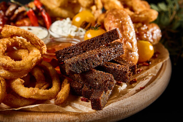 Enjoying a Beer Snack Assortment - Toast, Sausages, Calamari, Onion Rings, Buffalo Wings