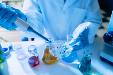 Modern medical research laboratory. female scientist hands working with micro pipettes analyzing biochemical samples