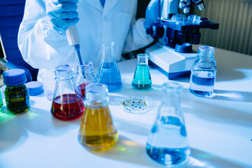 Modern medical research laboratory. female scientist hands working with micro pipettes analyzing biochemical samples