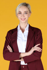 Portrait of young businesswoman smiling and raise her hand to the brown suit over yellow background