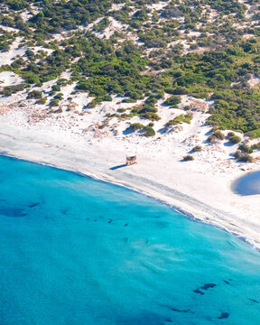 Aerial drone view of a rescue brigade hut on Plage de l'Ostriconi, Mediterranean beach during summer, island of Corsica, France.