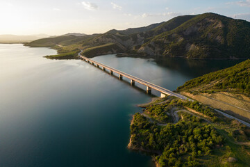 Aerial view of Lake Banjes with mountain peaks in sunset, Gramsh, Albania.