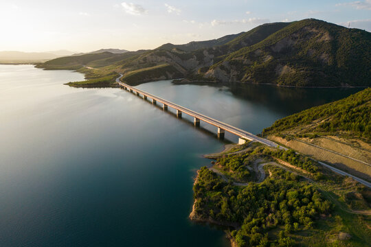 Aerial view of Lake Banjes with mountain peaks in sunset, Gramsh, Albania.
