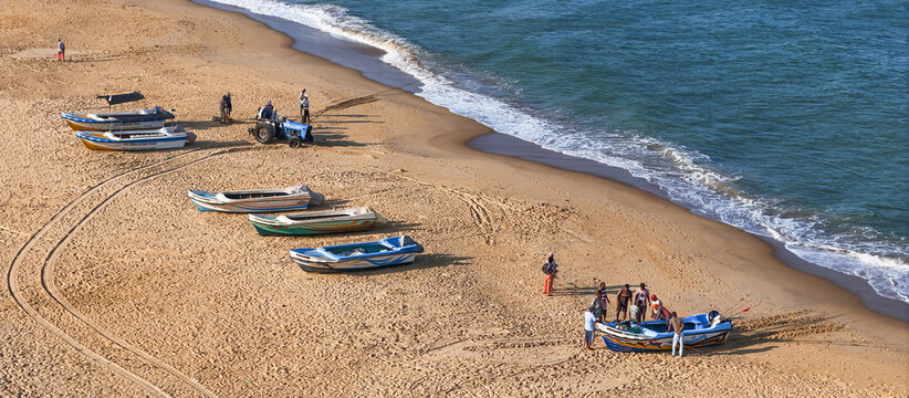 Aerial view of sandy beach with fishing boats and fishermen, Negombo, Sri Lanka.