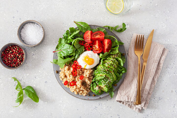 quinoa with poached egg, avocado tomato salad leaves. healthy vegetarian lunch breakfast