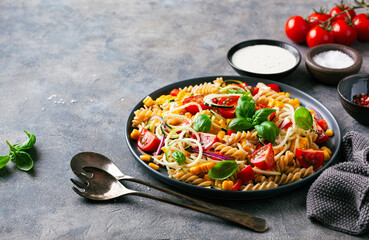 healthy pasta salad with zucchini sweet corn tomato and basil, vegetarian lunch