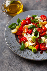 healthy colorful tomato mozzarella basil salad with balsamic vinegar dressing
