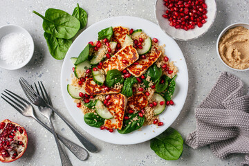 healthy halloumi cheese and couscous salad with cucumber spinach pomegranate hummus