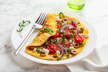 omelette with tomato, feta cheese onion and arugula. healthy keto diet low carb breakfast