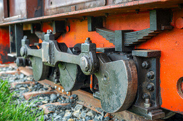 detail of wheels, transmission mechanism and suspensions of an old and small diesel locomotive